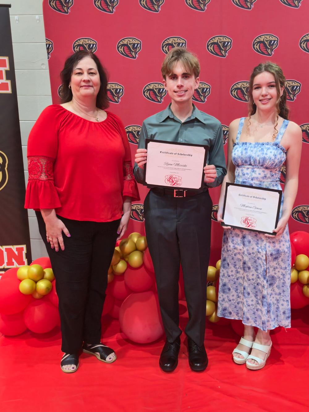 A JSL member stands with two graduating seniors holding their JSL certificates of scholarship at a high school awards night